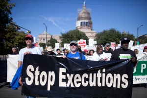 Exonerated former death row prisoners Gary Drinkard, Ron Keine, and Shujaa Graham lead a march in front of the Texas State Capitol